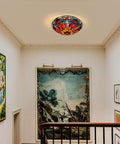 Lit Tiffany Style Stained Glass Ceiling Light 3 Lights 16 Inch Flush Mount Fixture displayed in hallway with artwork.