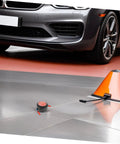Low Key No Stress Automatic Aerosol Fire Extinguisher 2 Pack with Heavy Duty Back Adhesive, shown beside a car on garage floor.