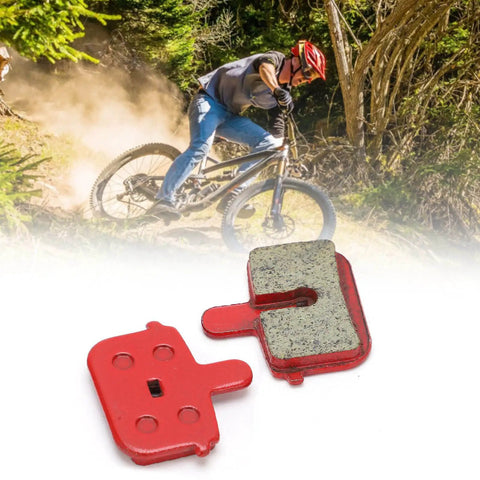 Image of 8 Piece Mountain Bike Disc Brake Pads Set With Resin Semimetal Material Quiet Braking Easy Install Go To Replacement Pads For Mountain Bikes Sized 29.5 X 30mm Fits Most MTB Brakes against a background of a mountain biker riding through a forest trail.