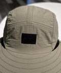 Close-up of lightweight sun hat with neck flap for unisex outdoor adventurers hiking camping and fishing gear, breathable polyester.
