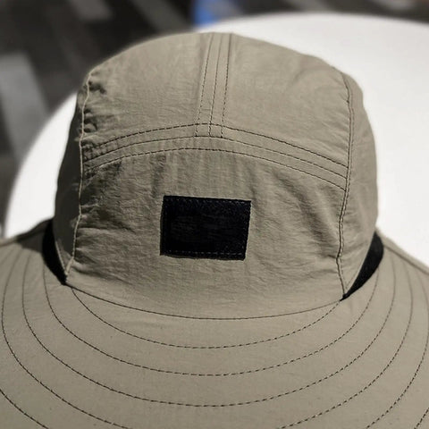 Close-up of lightweight sun hat with neck flap for unisex outdoor adventurers hiking camping and fishing gear, breathable polyester.