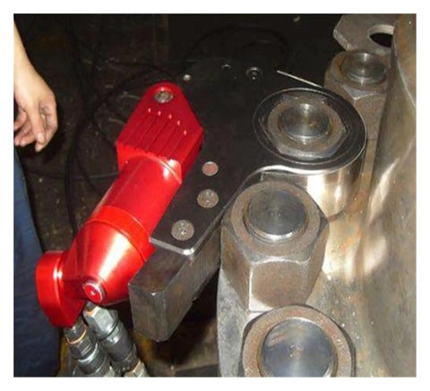 Heavy Duty Hydraulic Torque Wrench Generating 700 Bar Real Deal Pressure close-up on bolts with red swivel handle fitting.