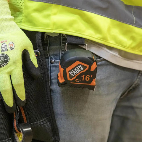 Rugged 16 Foot Tape Measure With Double Hook Double Sided Nylon Reinforced Blade And Metal Belt Clip in use on tool belt