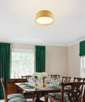 Modern 3 Light Flush Mount Ceiling Light with Fabric and Acrylic Double Drum Shade in flaxen over dining room.