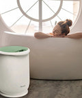 Huge 20L Towel Warmer Bucket for Bathrooms next to a bathtub with a woman relaxing, cozy spa vibe