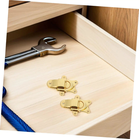 Retro Golden Metal Duckbilled Hasp Lock Toggle Latch Set on wooden drawer with a wrench and rope, ideal for DIY repairs.