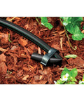 Black drip irrigation tubing in garden, Pro Grade One-Half Inch Drip Irrigation Distribution Tubing Fifty Foot Roll In Black Flexible