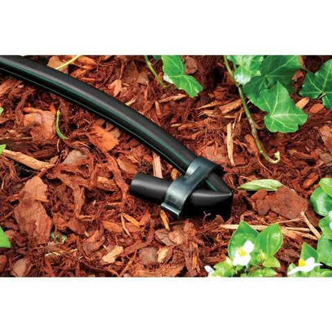 Black drip irrigation tubing in garden, Pro Grade One-Half Inch Drip Irrigation Distribution Tubing Fifty Foot Roll In Black Flexible