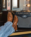 Rage 258 Guitar Combo Amp with 8 Inch Blue Marvel Speaker beside cowboy boots in a dressing room
