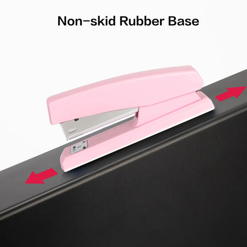 Pink Office Desktop Stapler With 25 Sheet Capacity And Holds Up To 120 Staples, shown with non-skid rubber base on a desk edge.