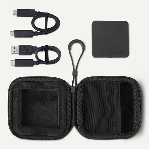 Beastly Fast 1TB Portable External SSD With Up To 2000MBps Read and Write Speeds USB 3.2 Gen 2 IP65 Water and Dust Resistant shown with cables and case