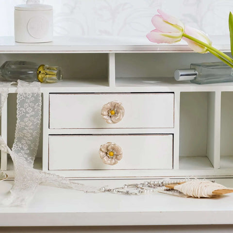 Premium Zinc Alloy Cabinet Knobs 4 Pack Featuring Floral Rhinestone Inlays on white dresser drawers with decorative items.