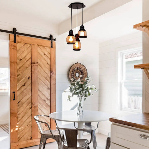 Vintage Farmhouse Pendant Lights Dope For Kitchen Island With 3 E26 Sockets Black Metal Glass Jar Chandelier Ceiling Fixture Adjustable Height To 43 Inches Rustic Dining Room Lighting, hanging over a dining table in a rustic kitchen.