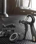 Adjustable Counting Grip Strengthener Kit 5 Pack with grip strengthener, finger trainer, ring, and ball in gym setting.