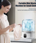 Solid Mini Portable Underwear Washer Featuring Rechargeable Battery And Ip67 Waterproof Frame For Dorm Apartment Rv Travel Deep Cleans Small Clothes Without Any Sweat Required, shown with a woman holding a small garment.