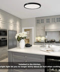 No Fuss Flush Mount LED Ceiling Light 18W 5000K Daylight in a modern kitchen setting with white cabinets and dining island.