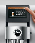 Person adjusting settings on automatic coffee machine with cold brew one touch brew and sweet hot specialty drinks 40 varieties.