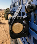 Close-up of 8 Piece Quick Release Shovel Holder Kit for Trucks and SUVs fits roof rack crossbars gripping wooden handle.