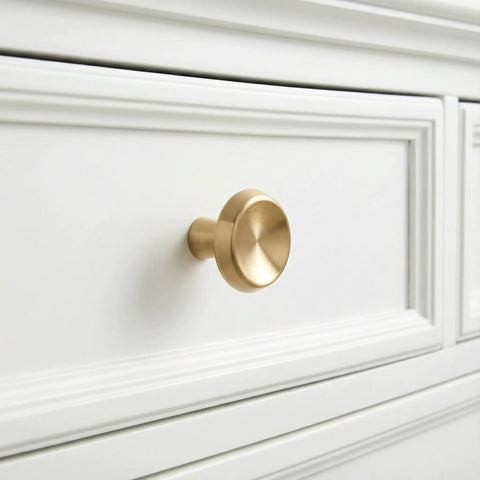 10 Pack Champagne Bronze Cabinet Knobs, 1.4 Inch Round Cabinet Pulls installed on white drawer, modern single hole zinc alloy handle