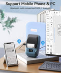 2 Inch Thermal Transfer Bluetooth Label Maker With Color Ribbon Printing For Waterproof Scratch Resistant Labels Ideal For Office Small Business School And Home Phone And PC Compatible Blue on a desk showing mobile and PC compatibility.