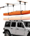 Orange kayak hoisted by heavy duty kayak storage hoist for garage ceiling with 180 lb capacity, overhead pulley system over Jeep Wrangler hardtop.