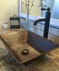 Oil Rubbed Bronze 1.5 Inch Non Overflow Pop Up Bathroom Sink Drain With Push Pop Top Design in a textured square sink