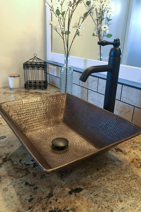 Oil Rubbed Bronze 1.5 Inch Non Overflow Pop Up Bathroom Sink Drain With Push Pop Top Design in a textured square sink