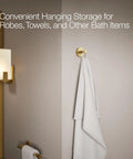 Elate Robe Hook In Vibrant Brushed Moderne Brass with white towel in bathroom for coordinating faucets and accessories