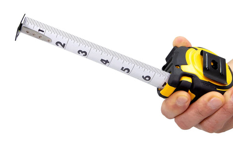 Person holding Beefed Up Heavy Duty 25 Foot Contractor TS Wide Blade Tape Measure With Backside Print And Manual Lock, blade extended