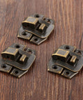 Three Antique Bronze Box Hasp Lock Set 20Pcs Vintage Jewelry Box Latches 24x19mm on wooden surface