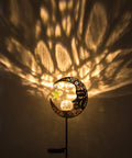 Lit Moonlit Solar Lantern For Outdoor Decor Ideal For Patio Path Garden Or Lawn Crackle Glass Globe Stake Light Waterproof Bronze Finish Warm LED Glow Easy Sun Powered Setup Upgraded Battery And Large Solar Panel casting patterns on wall