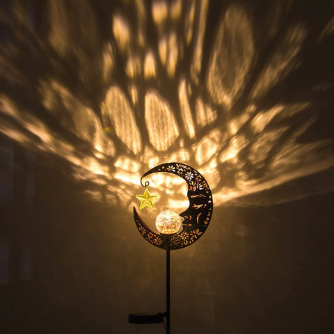 Lit Moonlit Solar Lantern For Outdoor Decor Ideal For Patio Path Garden Or Lawn Crackle Glass Globe Stake Light Waterproof Bronze Finish Warm LED Glow Easy Sun Powered Setup Upgraded Battery And Large Solar Panel casting patterns on wall
