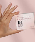 Instant Smudge Fix For Nails Smooths Dents And Imperfections Quick Dry Top Coat Booster Prime Manicure Glow Up Pack in hand.