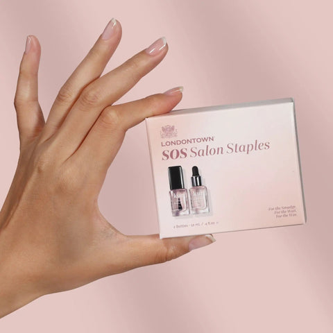 Instant Smudge Fix For Nails Smooths Dents And Imperfections Quick Dry Top Coat Booster Prime Manicure Glow Up Pack in hand.