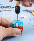 Hands using Dope Electric Jewelry Drill Kit With 74 Piece Set on resin pendant with tips display