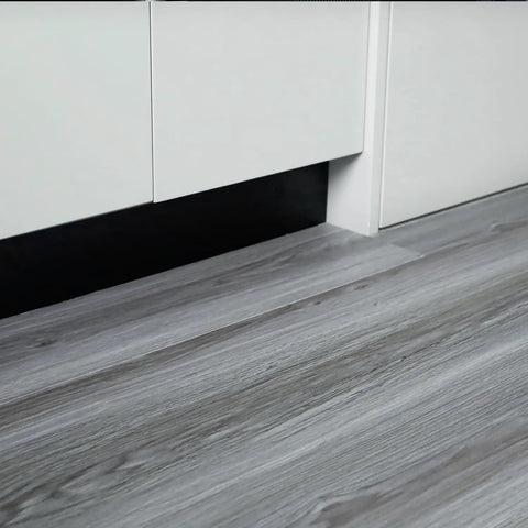 Real Wood Look Vinyl Floor Roll Featuring Dead Simple Peel And Stick Setup Super Wide Layout For Quick Room Makeovers Non Slip Grip and sleek grey wood grain surface in a kitchen setting.