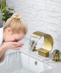 Woman using Gold Bathroom Sink Faucet With 3 Hole 2 Handle Crystal Knobs High Arc Waterfall Spout 8 Inch Widespread Vanity Basin Mixer Tap