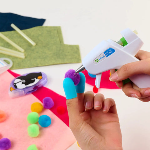 Hands using Low Temp Mini Hot Glue Gun 4 Pack White For Crafts And School Projects on colorful pom poms and felt.