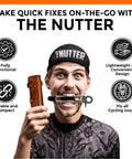 Man holding On The Go MTB Repair Multitool For Mountain Road And Dirt Bikes with multitool in mouth, compact brown case in hand