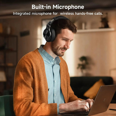 Man wearing Dual Mode Bluetooth Over Ear Headphones With 72 Hour Battery Life, Hi-Res Audio, Built-In Mic, using laptop wireless setup