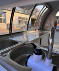 Interior view of a Ready To Roll Custom Mobile Food Truck Trailer with stainless steel prep sink and faucet.