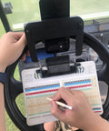 Rock Solid Golf Cart Phone Holder Steering Wheel Mount Spring Loaded Grip holds phone snug while player writes on scorecard.