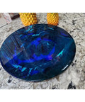 Ocean Resin And Wood Fifteen Inch Lazy Susan With Handcrafted Wave Pattern on a stone countertop