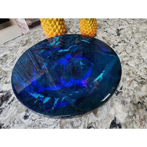 Ocean Resin And Wood Fifteen Inch Lazy Susan With Handcrafted Wave Pattern on a stone countertop