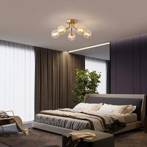 Bedroom with Gold Five Light Sputnik Style Ceiling Light Semi Flush Mount With Glass Globe Pendant Lamps installed.
