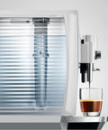 Automatic Espresso Machine With 17 Coffee Specialties, Barista Grade Milk Frothing, shown side view dispensing espresso