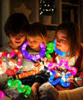 Kids playing with Glow Pop Tube Wand Toys For Kids And Toddlers Six Color Light Up Tubes for camping fun and party accessories.