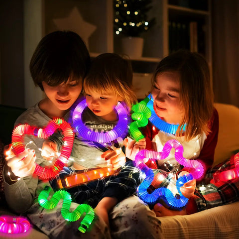 Kids playing with Glow Pop Tube Wand Toys For Kids And Toddlers Six Color Light Up Tubes for camping fun and party accessories.