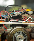 Three Pack Aluminum 25T Steering Servo Arm Horn Set For DIY RC Cars Boats And Planes, 31mm Length, 7mm Thick, 3mm Holes, High Torque Coreless Servo Accessory In Purple mounted on RC chassis