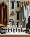 12 Pack Zipper Pull Replacement Kit in Black and Coffee, detachable tabs shown on table with coats and bags in background.